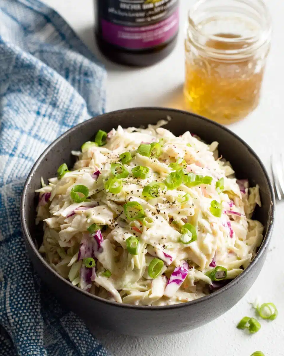 Whole30 Classic Coleslaw with Green Onions Creamy Whole30 classic coleslaw in a bowl with green onions and pepper