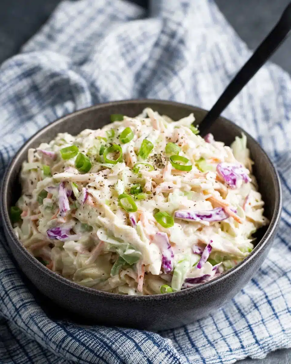Whole30 Classic Coleslaw with Creamy Dressing Whole30 classic coleslaw in a bowl with green onions and black pepper