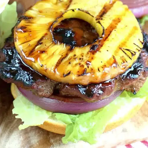 Grilled teriyaki burger with pineapple and red onion on a toasted bun