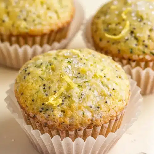 Lemon poppy seed zucchini muffins with sparkling sugar and lemon zest
