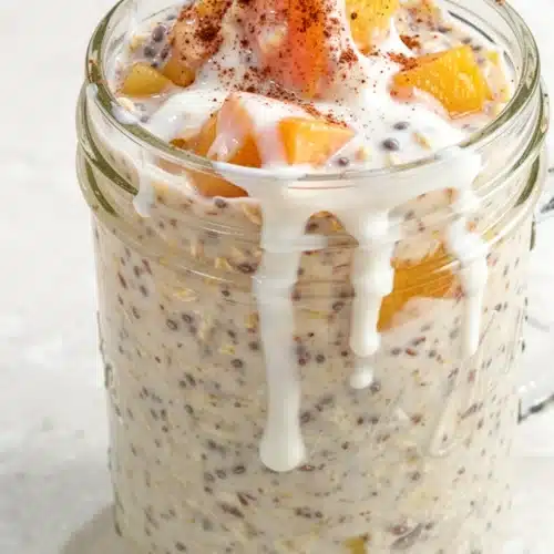 Overnight peach cobbler oatmeal in a jar with peaches and cinnamon