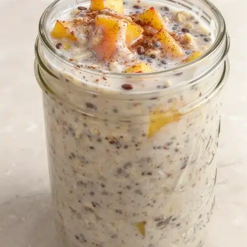 Overnight peach cobbler oatmeal in a jar with peaches and cinnamon