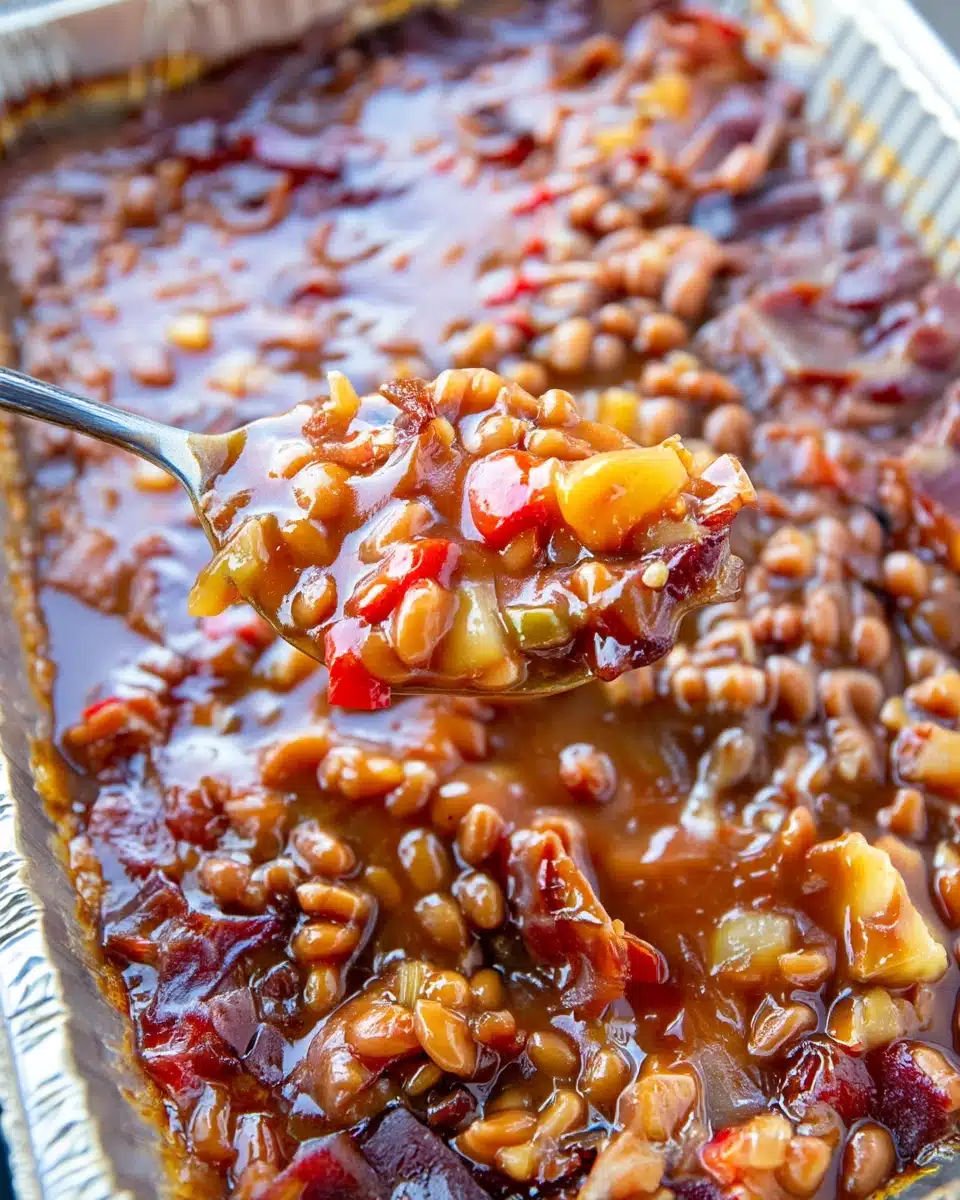 Smoked baked beans with bacon, pineapple, and peppers in a foil pan