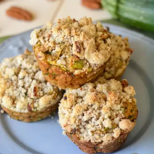 Zucchini coffee cake muffins with crumb topping on a plate