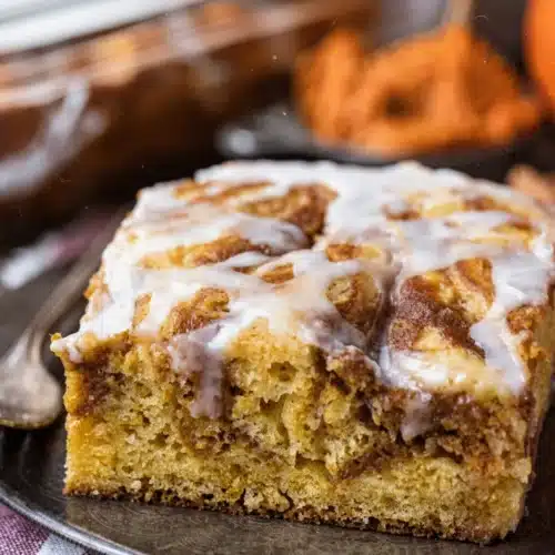 Easy Pumpkin Swirl Cake: Irresistibly Delicious and Simple 1 Easy pumpkin swirl cake slice with white glaze and visible swirls, served on a plate