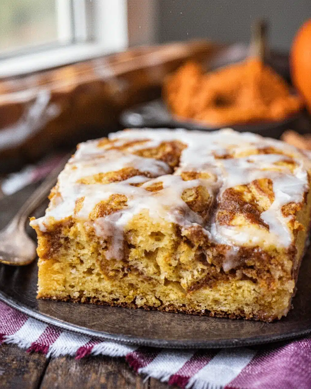 Easy Pumpkin Swirl Cake with White Glaze Easy pumpkin swirl cake slice with white glaze and visible swirls, served on a plate